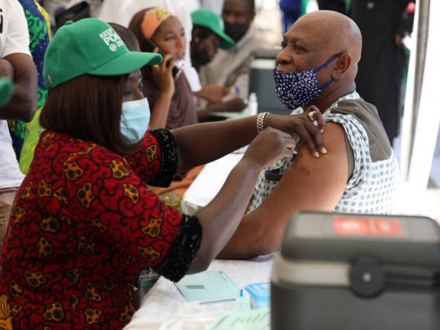 A healthworker administers a Covid-19 vaccine in Abuja, Nigeria