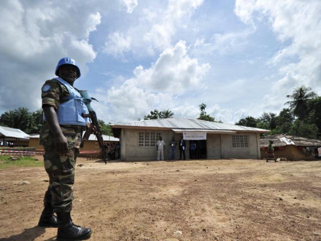 A United Nations peacekeeper patrols as Liberian incumbent President Ellen Johnson Sirleaf casts her ballot in her hometown of Fefeh Town on 8 November 2011