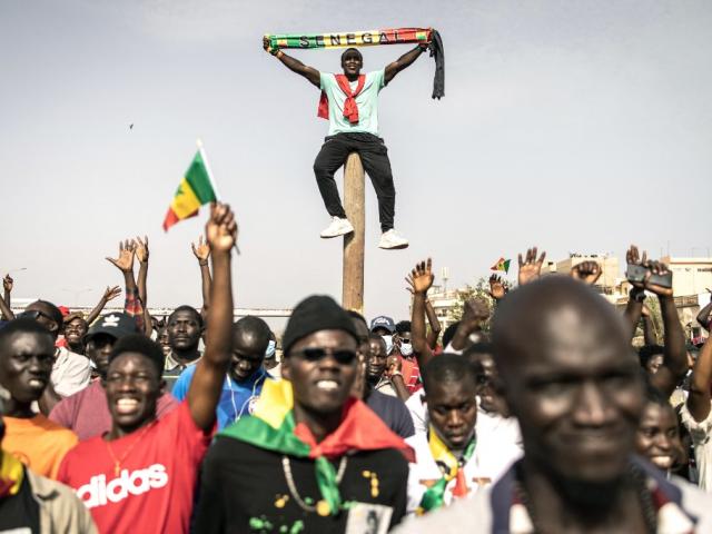 Des partisans du Mouvement de défense de la démocratie (M2D) réagissent lors d'un rassemblement à Dakar, le 23 juin 2021, pour célébrer le dixième anniversaire des manifestations de 2011 qui appelaient à mettre fin à l'éventuel troisième mandat de l'ex-président Abdoulaye Wade et à dénoncer l'éventuel troisième mandat de l'actuel président Macky Sall. JOHN WESSELS / AFP