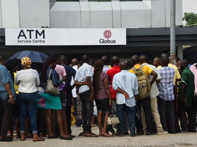 People queue to withdraw new naira notes from a bank ATM in Lagos, 1 February 2023.