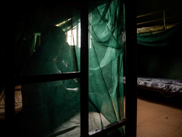 A woman and her child rest in a shelter in Benin City, Nigeria, in 2019.