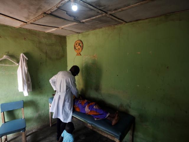 A doctor examines a pregnant woman in Nigeria