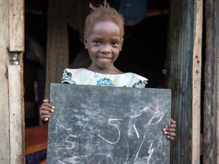 Susan Andua, 5, outside her mother Florence’s house in Nimule, South Sudan. Photo: UNICEF/UNI203956/Everett