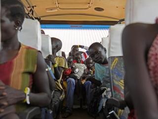 Newly arrived refugees from South Sudan sit in a bus at the Elegu Collection Centre in Amuru, Uganda, in July 2016. Photo: AFP/Isaac Kasamani