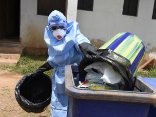 A health official wears protective gear to empty medical waste from the treatment of Lassa fever patients in the Irrua Specialist Teaching Hospital in Irrua in Nigeria's Edo State in March 2018. Photo: AFP/PIUS UTOMI EKPEI