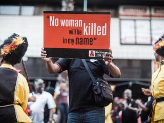 A man holds a banner during a protest march in June 2018 in Durban against child abuse, femicide and other social ills. Photo: AFP/RAJESH JANTILAL