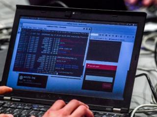 A person works at a computer during the 10th International Cybersecurity Forum in Lille in January 2018. Online crime is a concern in South Africa. Photo: AFP /PHILIPPE HUGUEN